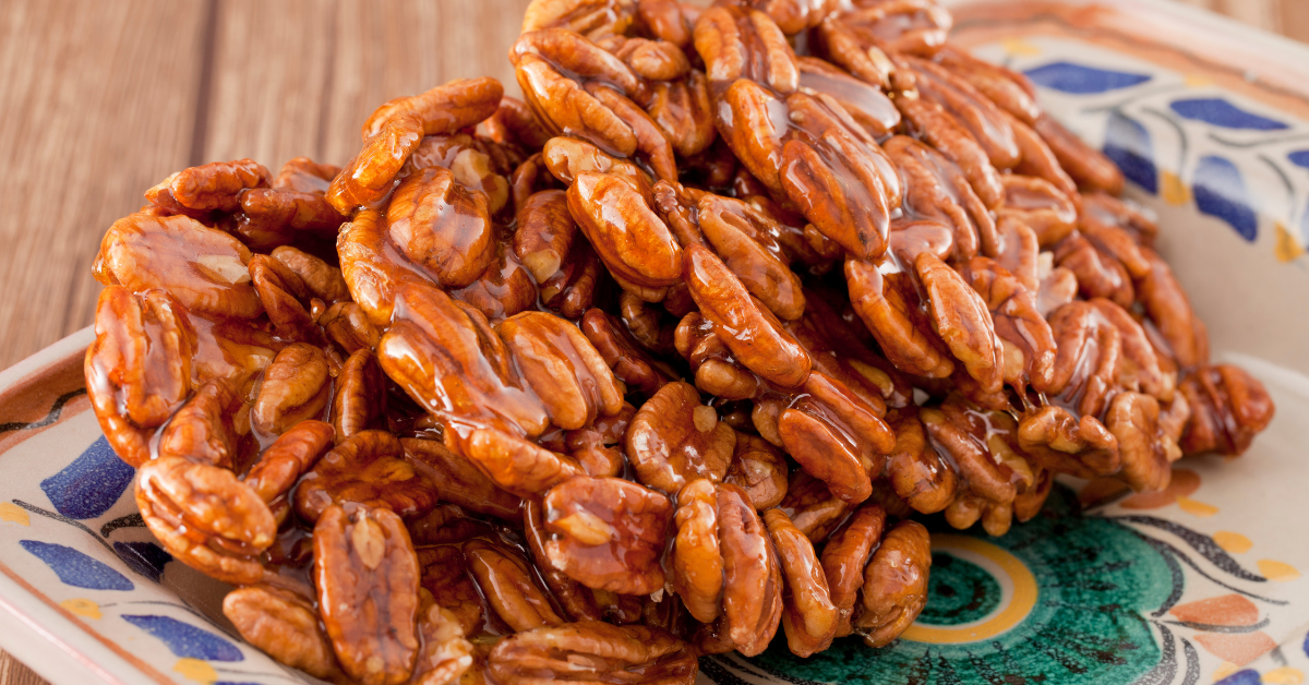 a pile of candied pecans on a plate